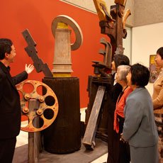 Volunteer guide with visitors to the Gallery