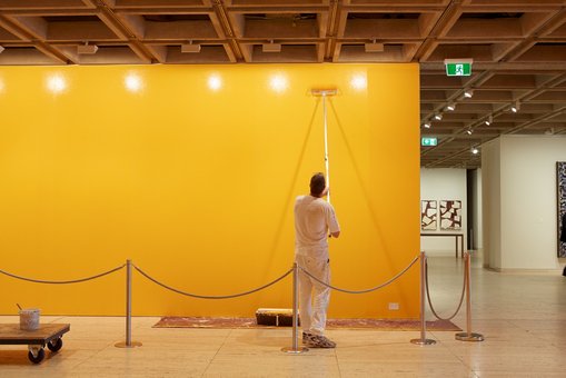 The 'sunshine yellow’ wall colour for Public notice 2 was mixed by our paint team in consultation with the artist Jitish Kallat.